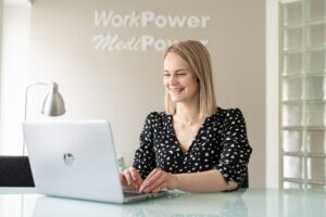 MediPower’s Miia smiling at the office.