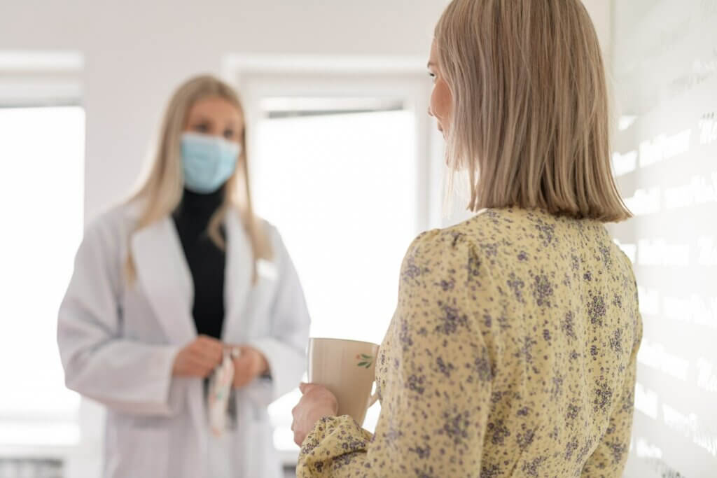 A MediPower office professional and a healthcare worker in conversation.